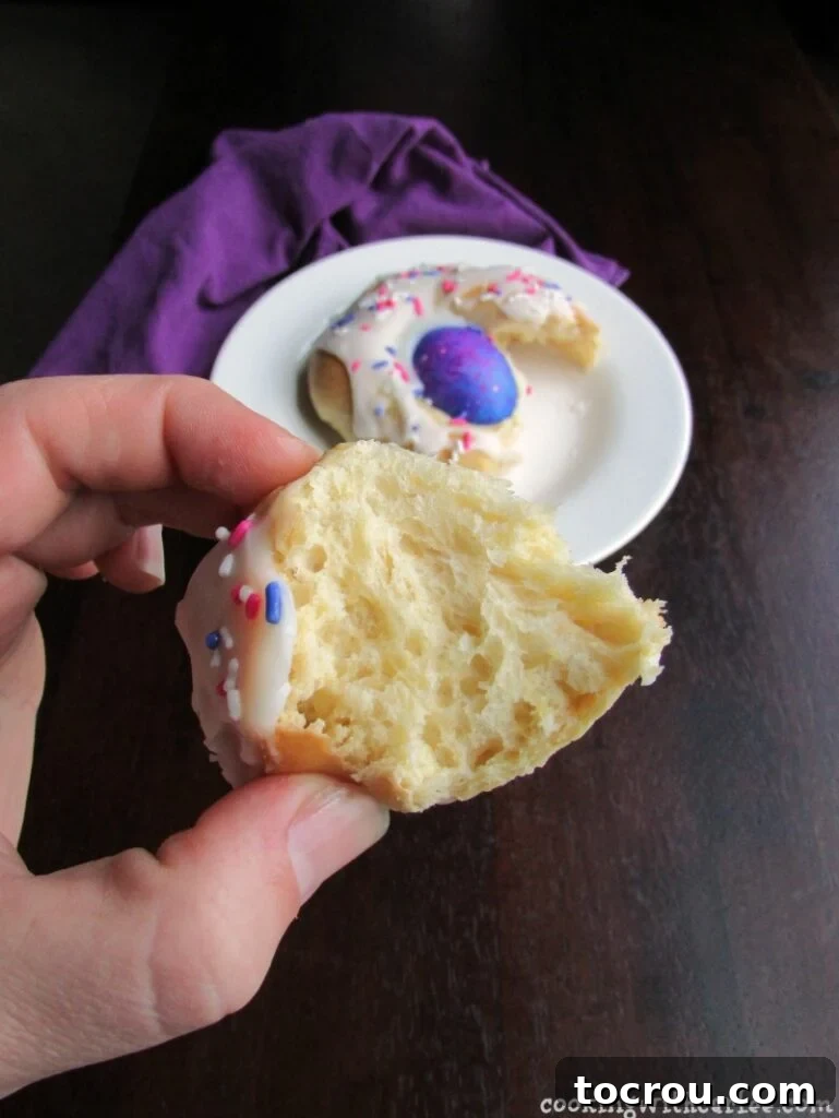 hand holding piece of easter bread with soft interior showing.