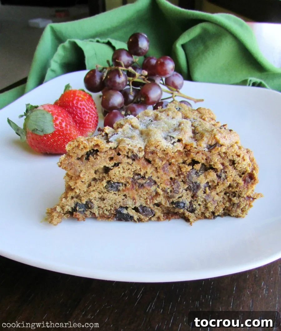 Irish Fruit Tea Loaf 5 slice of raisin and date filled Irish tea brack on plate with grapes and strawberries.