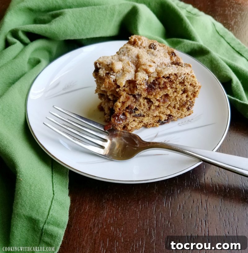 Irish Fruit Tea Loaf 6 slice of tea brack cake with raisins and dates on plate with fork, bite missing.