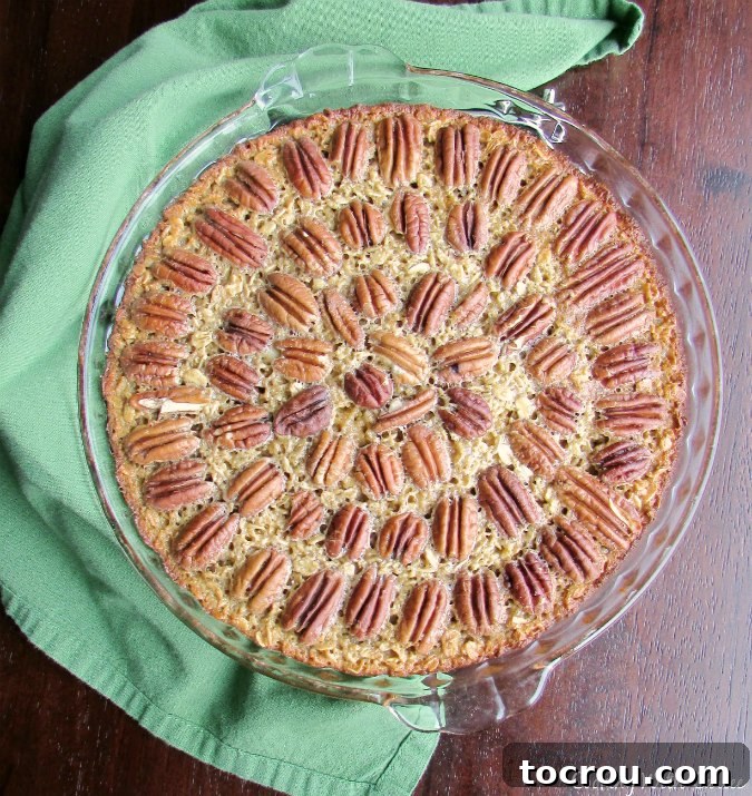 Pecan Pie Baked Oatmeal: Your New Favorite Breakfast Indulgence A deep pie plate filled with warm pecan pie baked oatmeal, fresh from the oven, ready to be served.