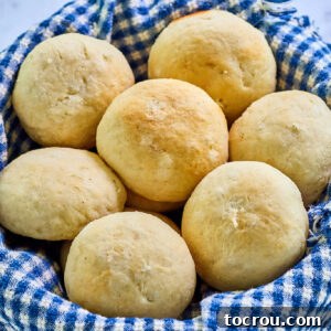 Close up of basket of homemade potato rolls showing their round shape and buttery golden brown tops.