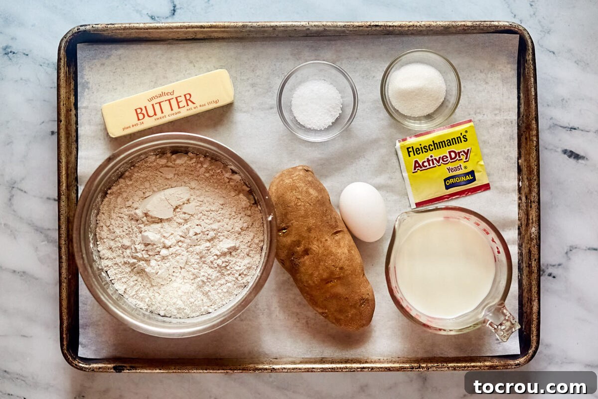 Ingredients including flour, potato, egg, milk, yeast, butter, salt, and sugar ready to be made into homemade potato rolls.