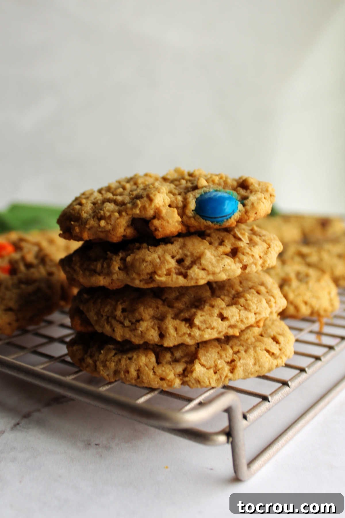 Cooling Freshly Baked Monster Cookies Stack of fresh monster cookies on cooling rack.