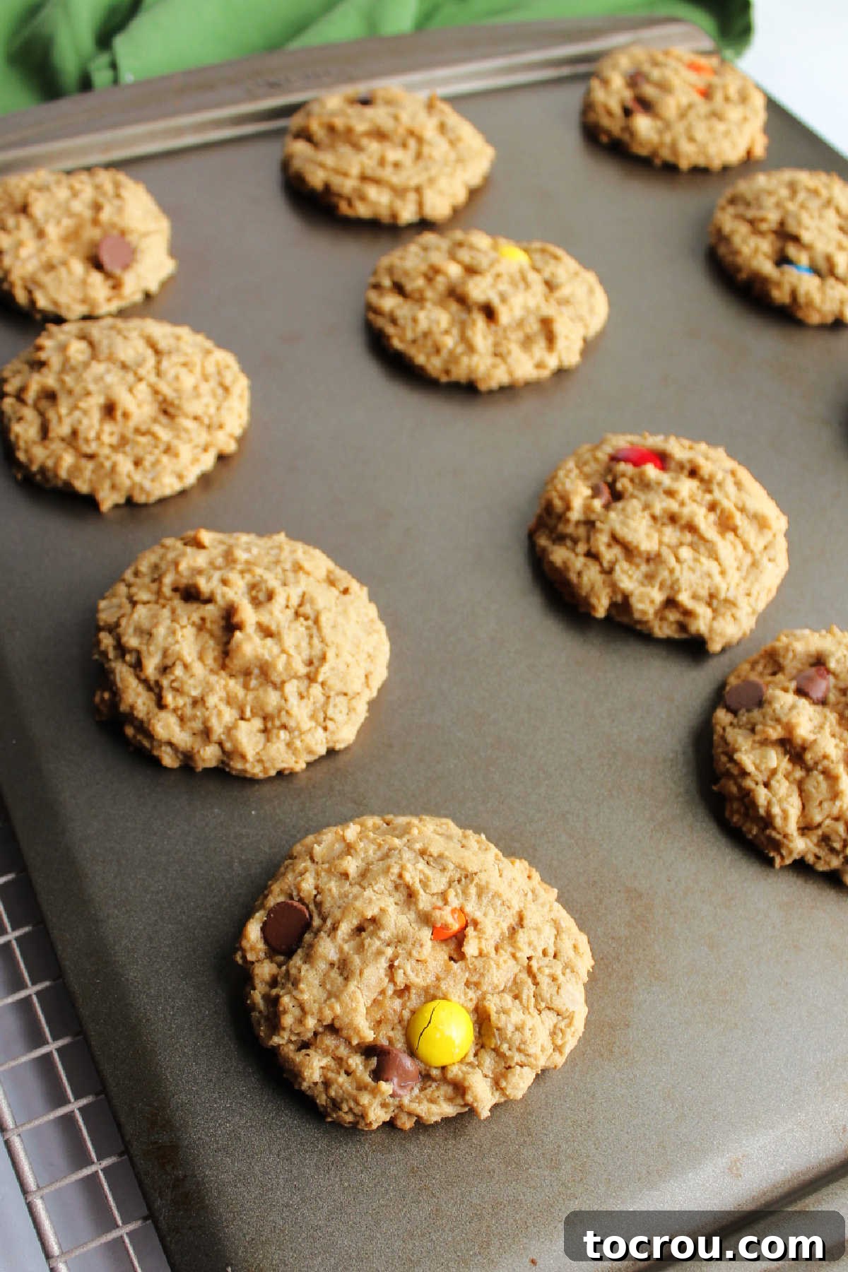 Hot Monster Cookies Straight from the Oven Freshly baked monster cookies on baking sheet.