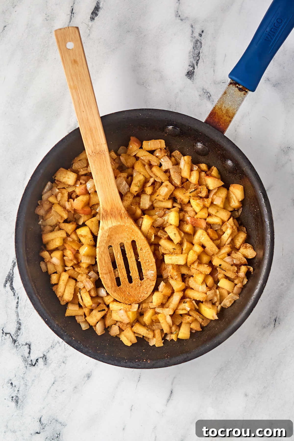 Caramelized Apple Filling Skillet with cooked apple mixture, browned from being cooked and the balsamic vinegar inside.