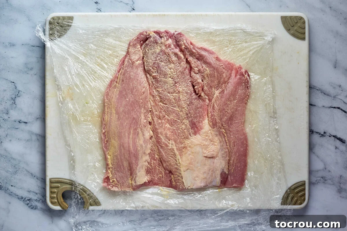Butterflied Pork Loin with Dijon Butterflied pork loin rubbed with mustard, ready to be filled.