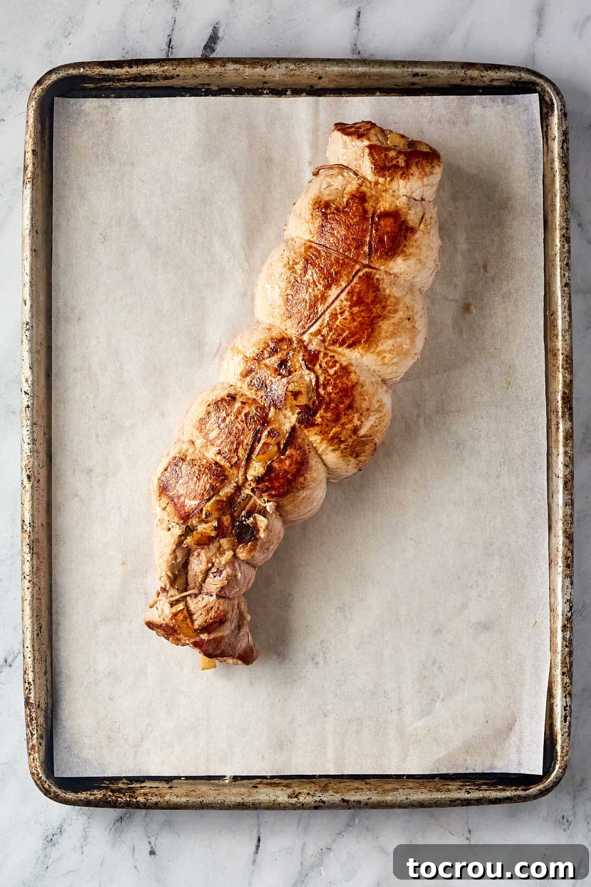 Perfectly Browned Stuffed Pork Loin Browned apple stuffed pork loin, ready to be sliced and served.