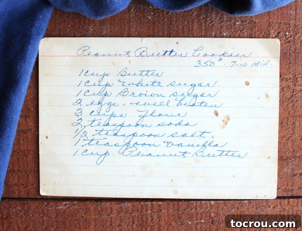 Grandma's Irresistible Peanut Butter Cookies 3 An aged index card with a peanut butter cookie recipe meticulously written in grandma's elegant cursive handwriting, showcasing its family legacy.