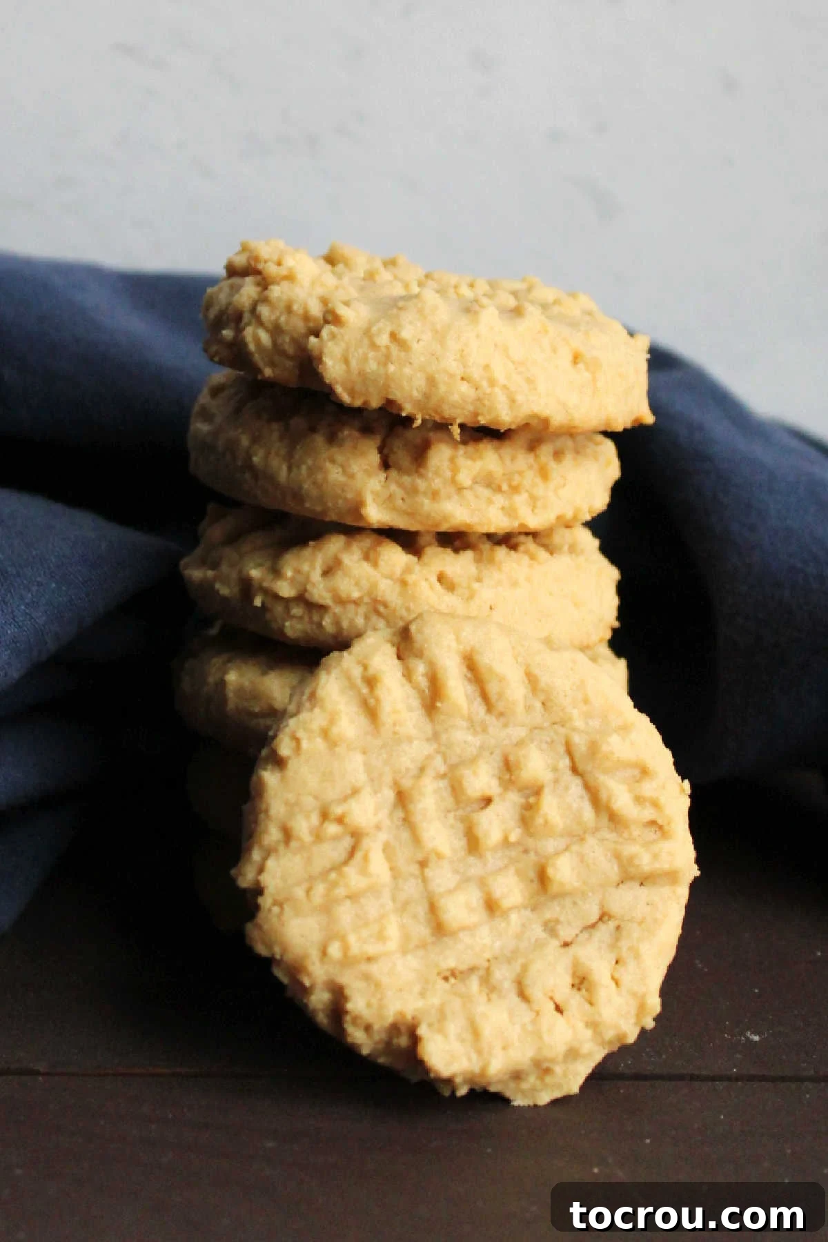 Grandma's Irresistible Peanut Butter Cookies 7 A delectable stack of soft, golden peanut butter cookies, perfectly baked and ready to be enjoyed.