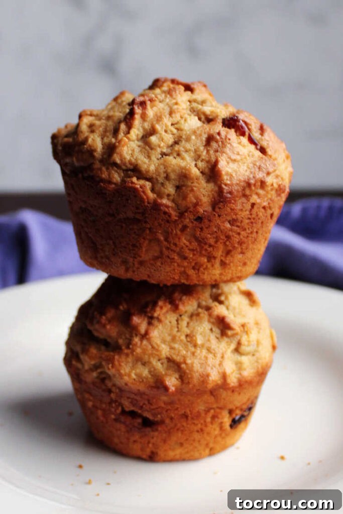 Stack of cranberry sourdough muffins on a plate, ready to be served.
