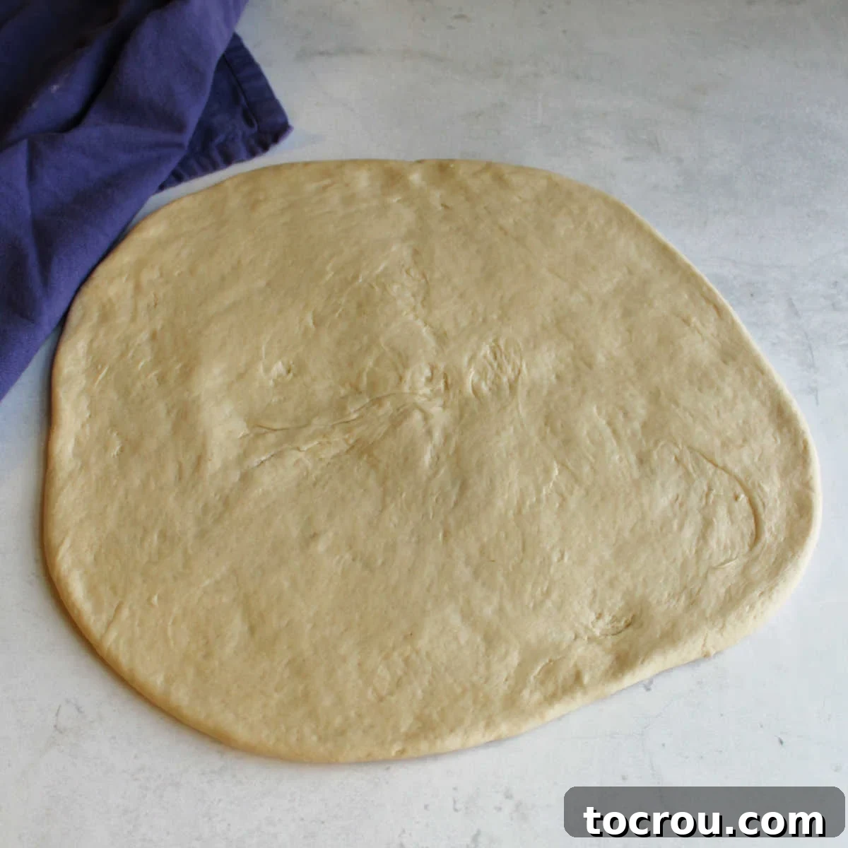 Perfect Sourdough Pizza Dough Circle of sourdough pizza dough ready to be topped and cooked.