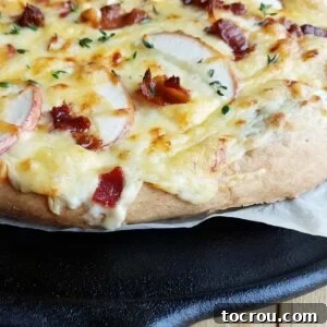 Close up of side of savory apple bacon pizza with sourdough crust.