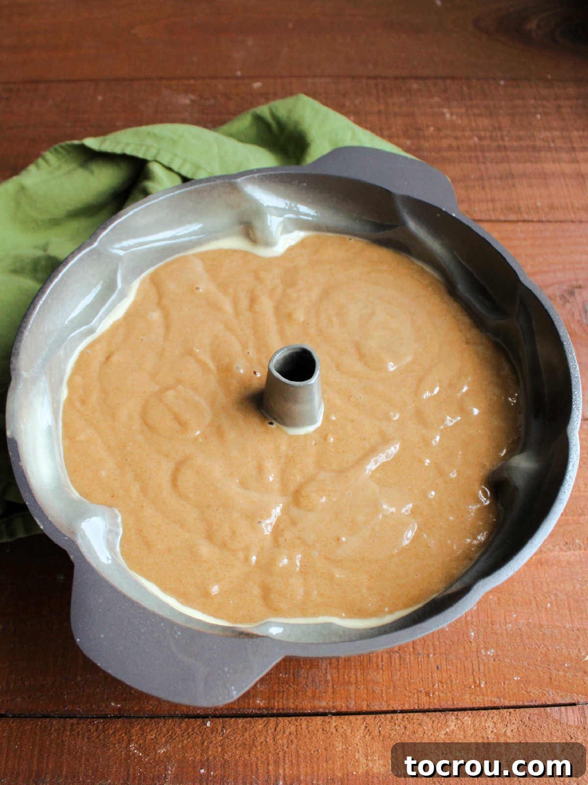 Cider Mill Bundt Cake 2 Tan apple cider cake batter in prepared bundt pan, ready to go in the oven.