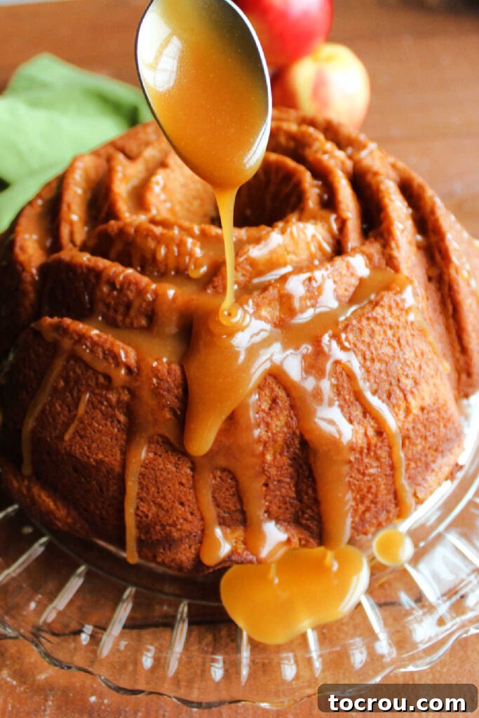 Cider Mill Bundt Cake 4 Spooning apple cider caramel sauce over bundt cake.