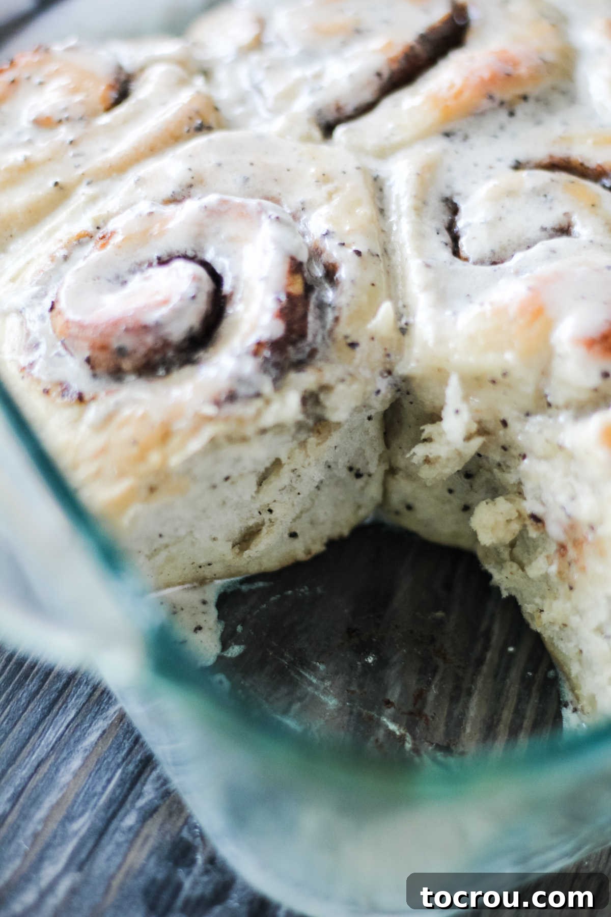 Soft Coffee Cinnamon Roll Texture Pan of coffee cinnamon rolls with one missing, showing soft texture of dough, cinnamon coffee filling, and vanilla coffee glaze.