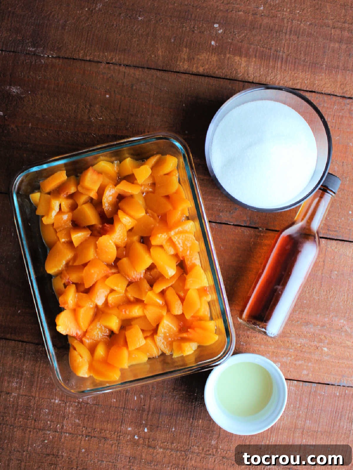 Peach Sauce Ingredients Essential ingredients for homemade peach sauce laid out: vibrant chopped peaches, fresh lemon juice, granulated sugar, and fragrant vanilla extract.