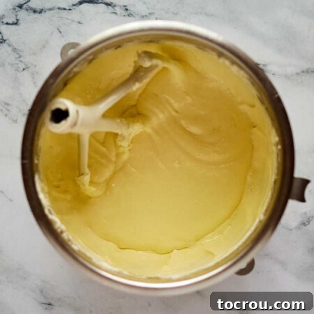 Decadent Brownie Chunk Cheesecake with Mocha Cloud Topping 13 Smooth and creamy cheesecake batter in mixing bowl.