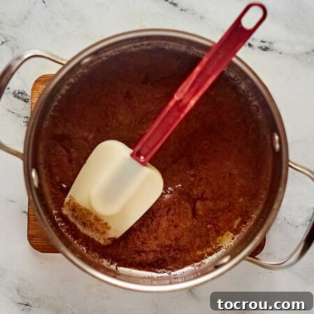 Decadent Brownie Chunk Cheesecake with Mocha Cloud Topping 8 Saucepan with melted chocolate and butter mixture ready to be made into brownies.