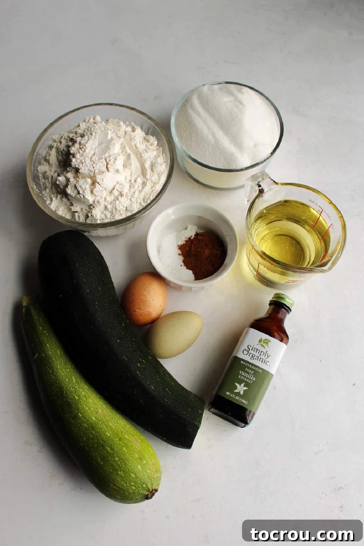 Gathering fresh ingredients for homemade mini zucchini bread. Fresh ingredients laid out on a kitchen counter, ready to be transformed into delicious zucchini bread.