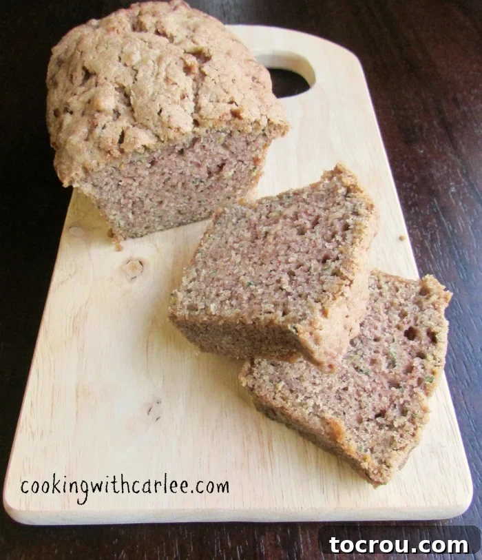 Delicious slices of mini zucchini bread, ready to enjoy. Several slices of freshly baked mini zucchini bread loaf arranged neatly, showcasing its moist interior.