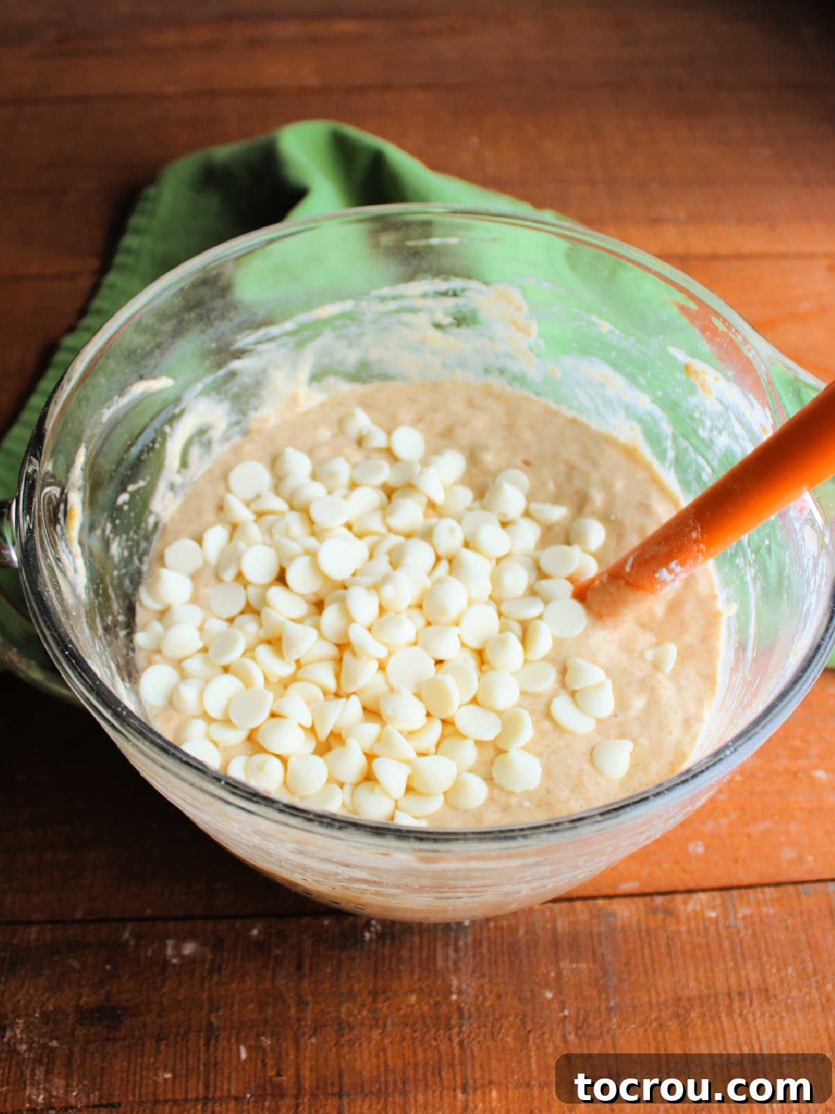 Artisan Sourdough Orange Dream Muffins 4 Sourdough muffin batter with white chocolate chips on top, ready to be stirred in.