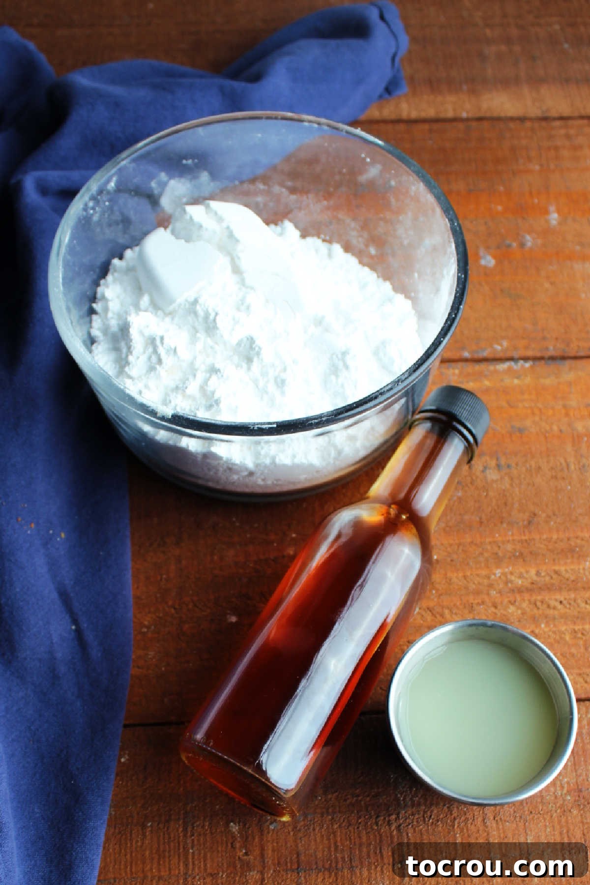 Lemon glaze ingredients Glaze ingredients including powdered sugar, lemon juice, and vanilla extract.