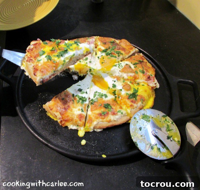 A delectable slice of Croque Madame pizza, fresh from the oven, with its golden crust, melted cheese, and a perfectly cooked sunny-side-up egg, ready to be enjoyed.