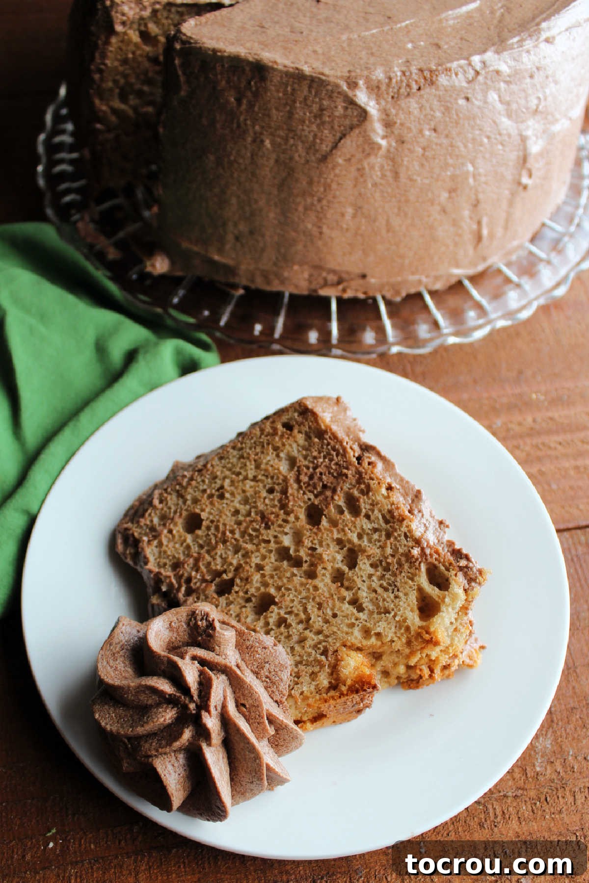 Velvet Mocha Cloud Frosting 2 Swirl of mocha ermine frosting on plate with coffee angel food cake slice.