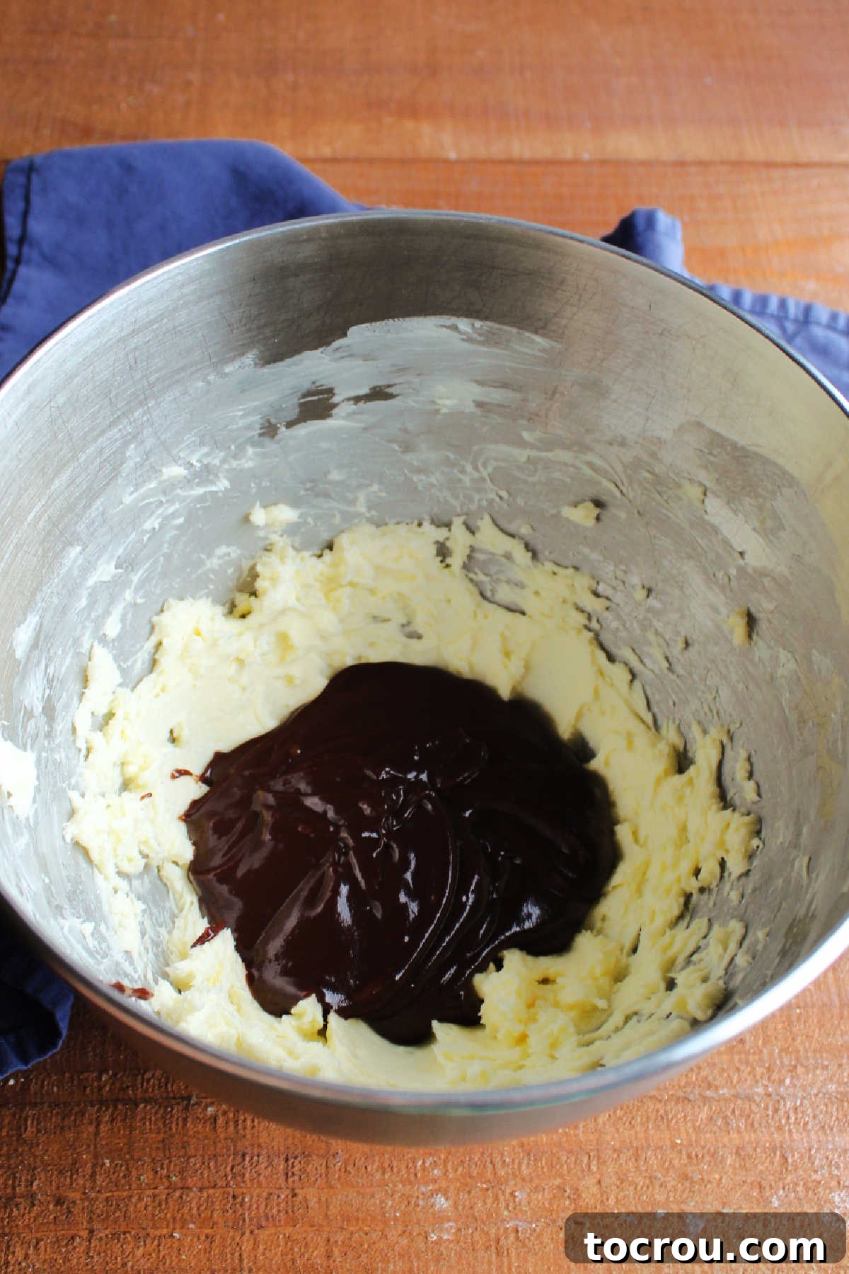 Velvet Mocha Cloud Frosting 7 Chilled chocolate boiled milk mixture in mixer bowl with whipped butter.