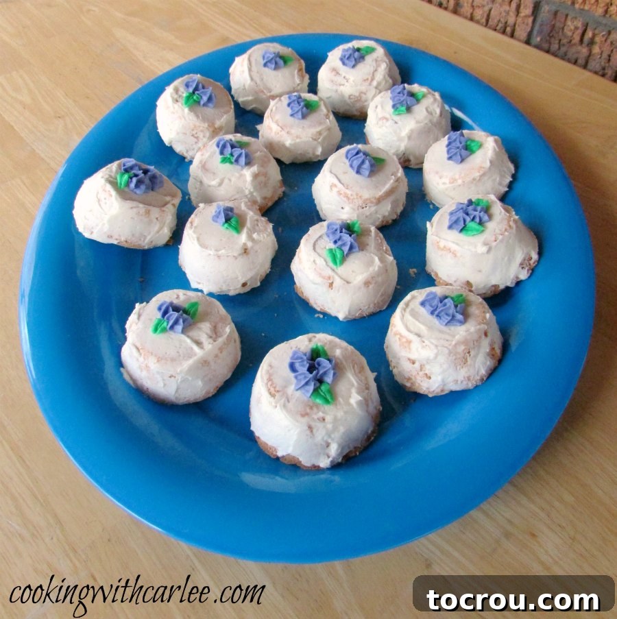 Ready-to-Serve Angel Food Cupcakes A large blue platter showcasing frosted angel food cupcakes, meticulously arranged and ready for serving at an event or gathering.