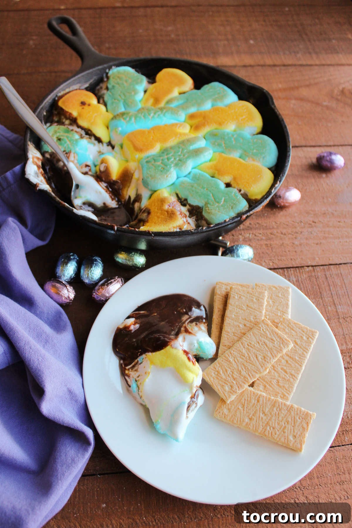 Individual Serving of Peeps S'mores Dip Serving of gooey smores dip on plate with graham crackers, ready to eat.