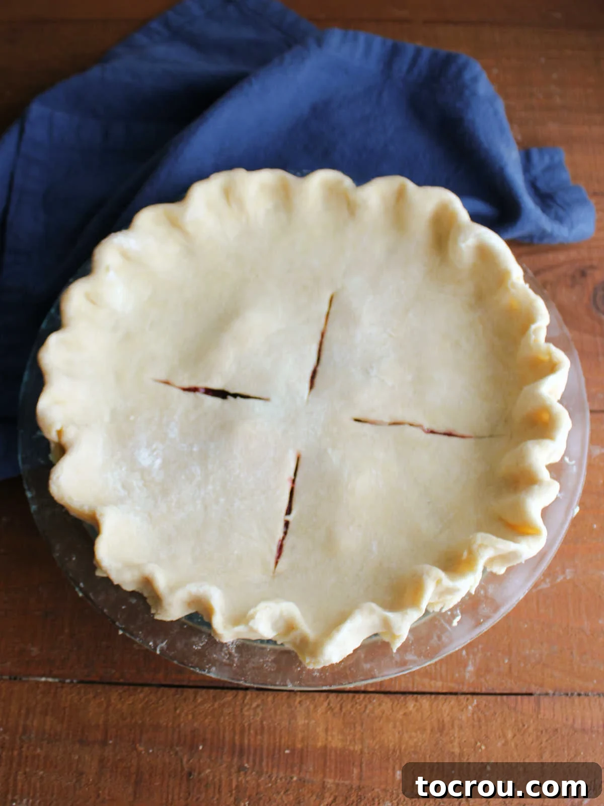 Cherry berry pie after the top crust has been added, the edges crimped and vent slits cut, ready for the oven.