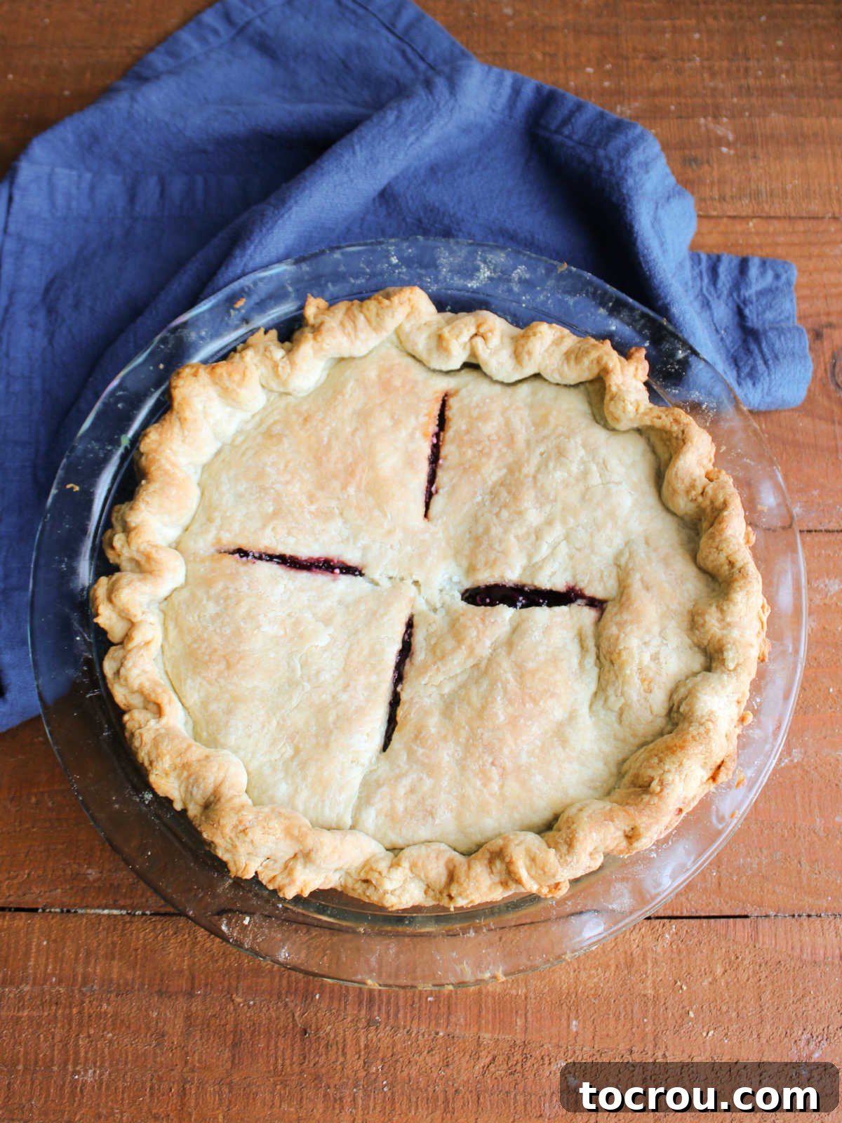 Baked cherry berry pie with golden brown crust and thickened fruit filling.