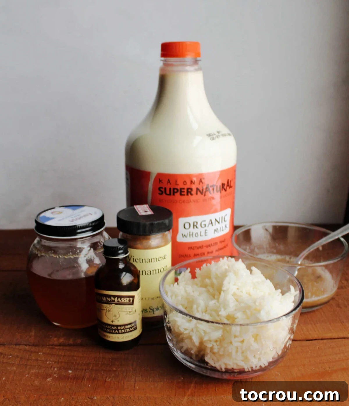 Golden Banana Rice Pudding 2 Banana rice pudding ingredients, cooked rice, milk, cinnamon, vanilla, mashed banana and honey ready to be cooked.