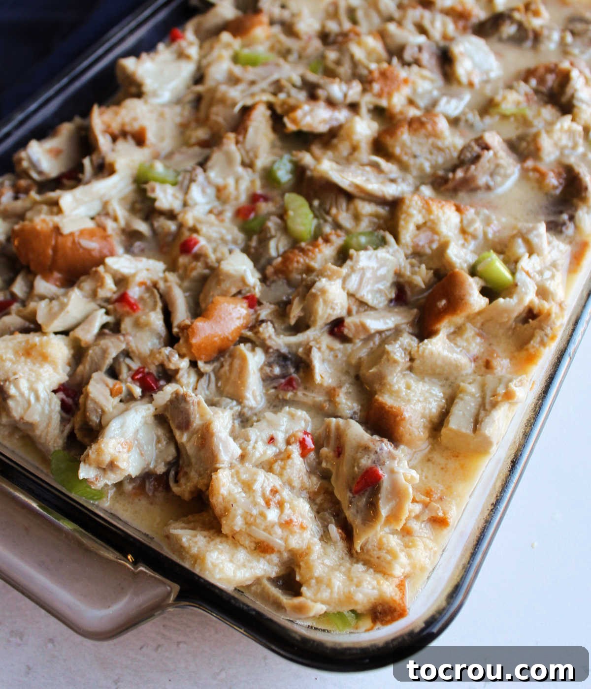 Comforting Turkey and Rice Casserole with Rich Gravy 4 The turkey casserole mixture evenly spread in a baking pan, poised to go into the oven.