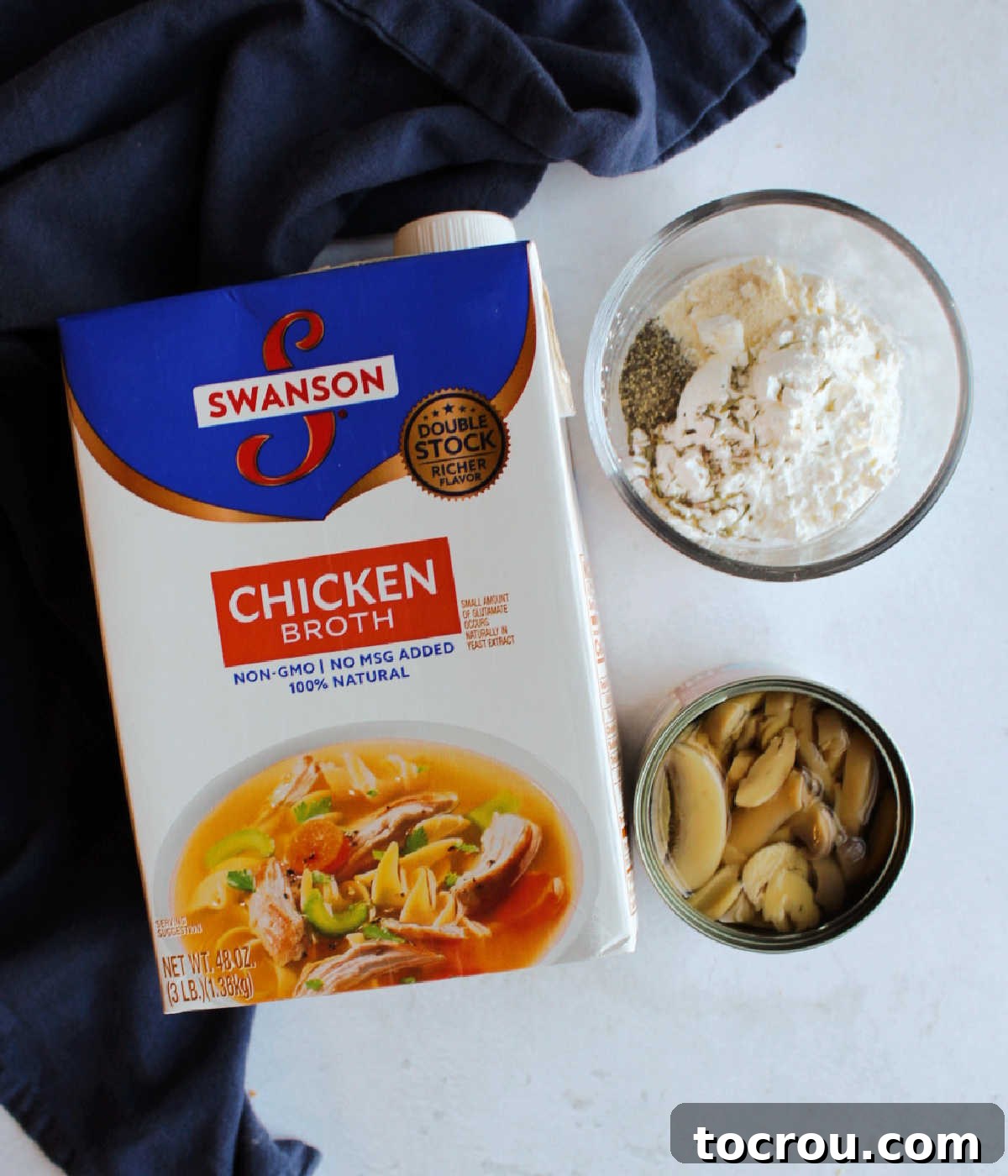 Comforting Turkey and Rice Casserole with Rich Gravy 5 Ingredients for homemade mushroom gravy: chicken broth, cornstarch, canned mushrooms, and seasonings laid out.