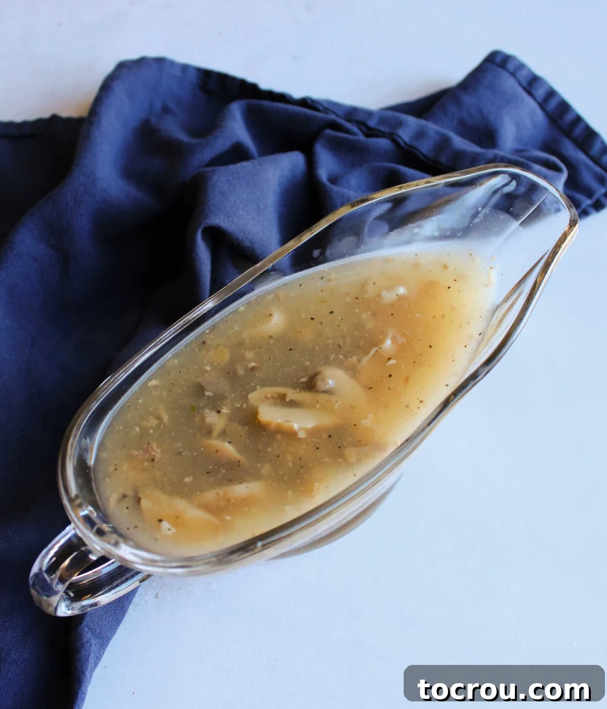 Comforting Turkey and Rice Casserole with Rich Gravy 6 A elegant gravy boat filled with rich, savory mushroom gravy, ready to be served.