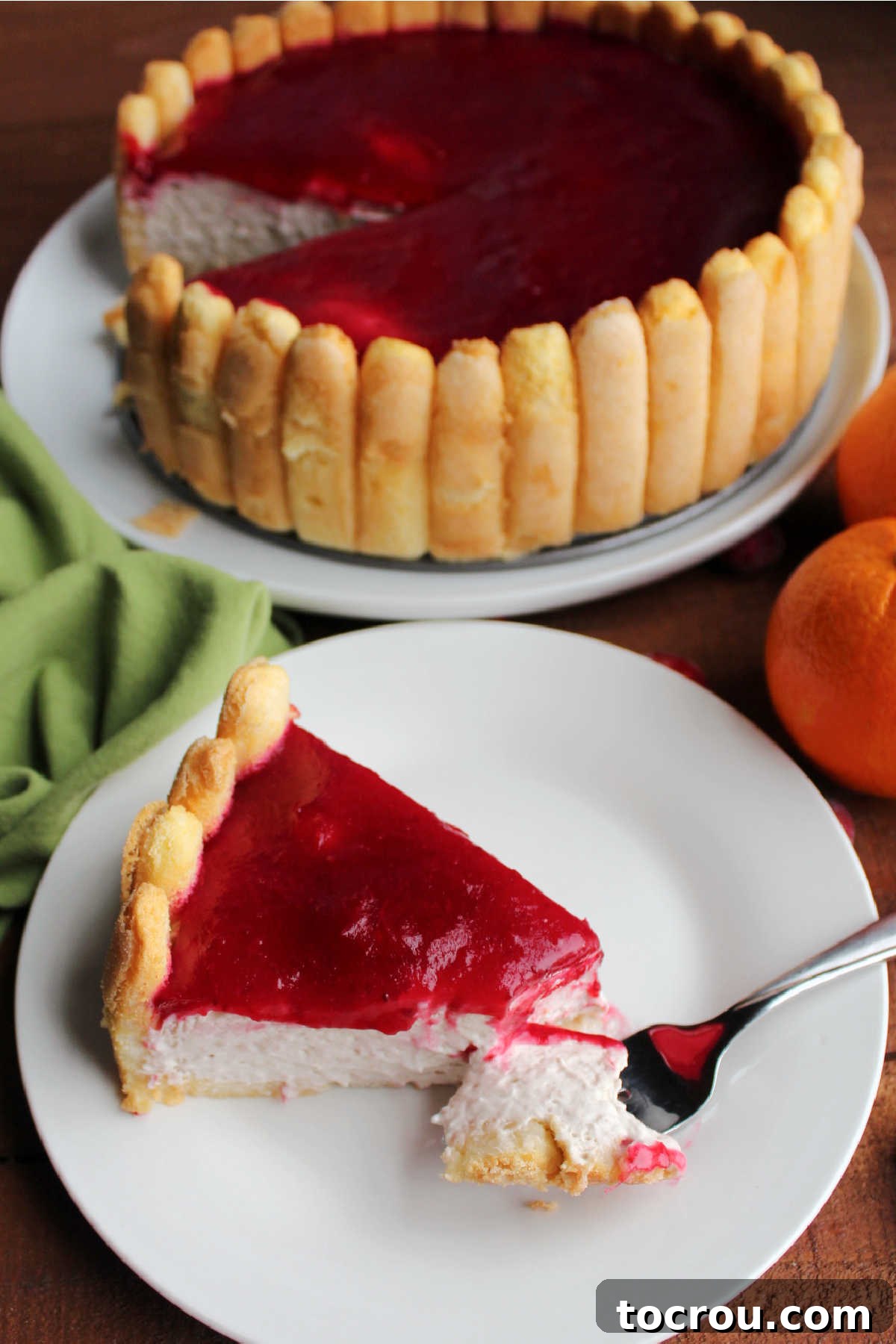 Bite of creamy orange cranberry and banana charlotte russe on fork showing showing the creamy texture of the center. 