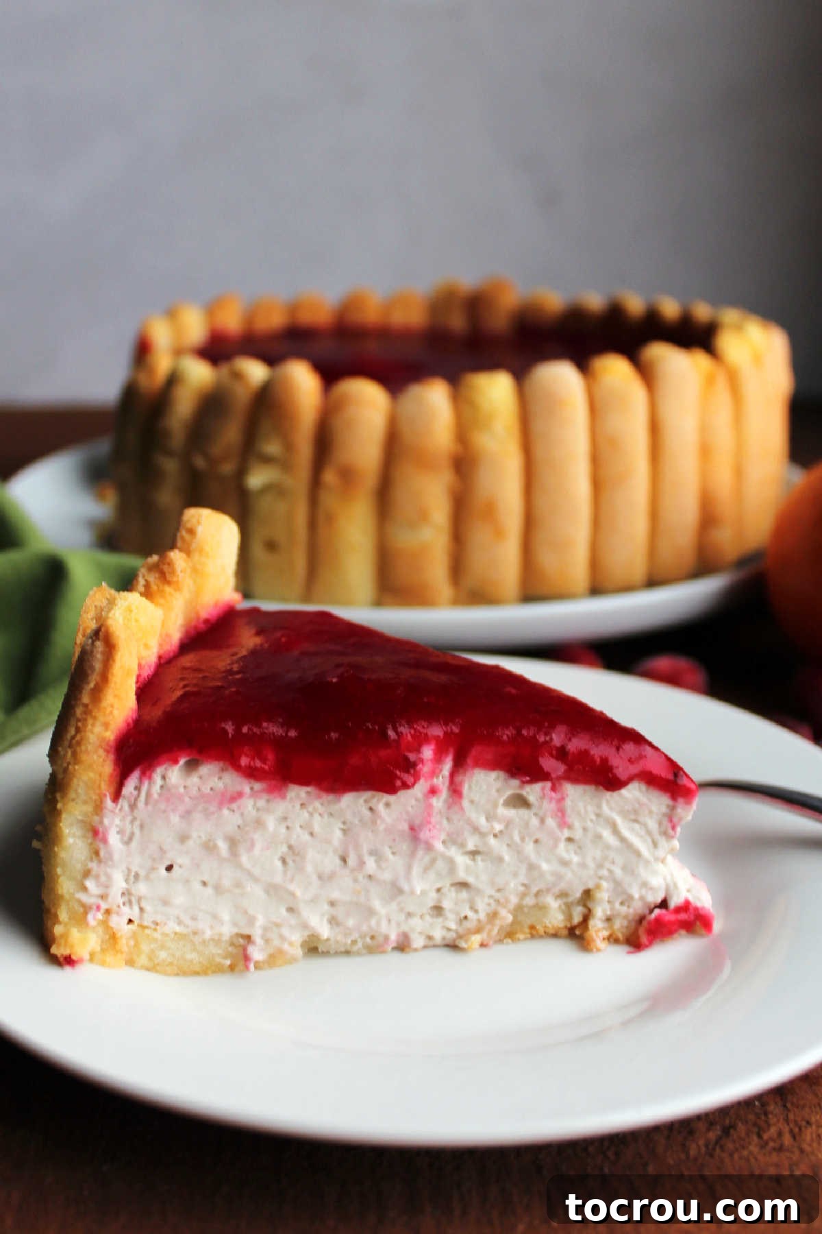 Slice of cranberry orange charlotte on small dessert plate showing the layers of goodness.