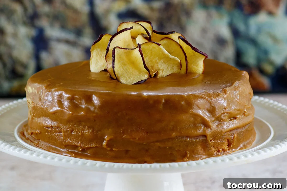 Southern Gold Caramel Frosting 2 Whole caramel cake with homemade caramel icing and apple chips on top, ready to be sliced and served.