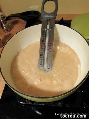 Southern Gold Caramel Frosting 3 Caramel boiling in saucepan with candy thermometer.