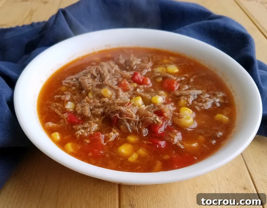 Overhead View of Brunswick Stew An overhead view of a bowl of rich BBQ Brunswick stew, filled with chunks of various meats, vibrant tomatoes, and sweet corn.