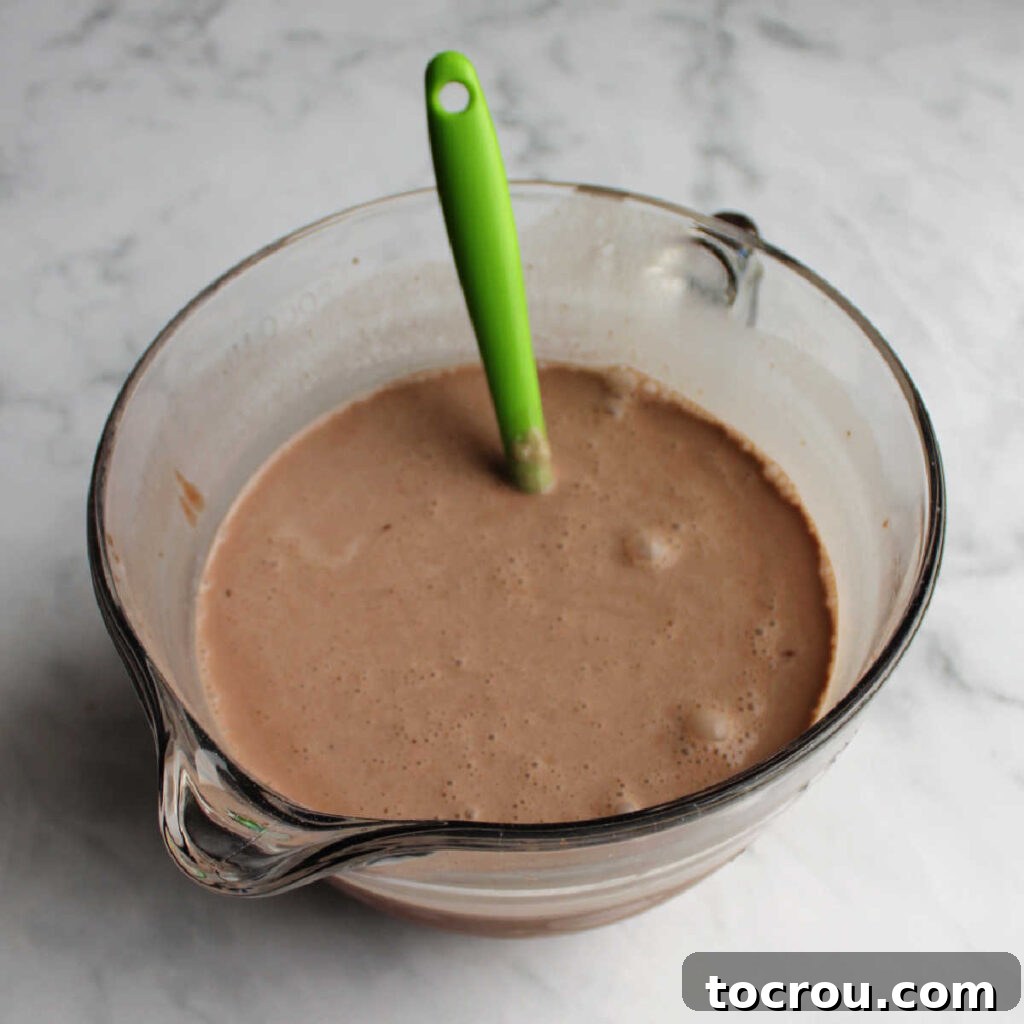 Brownie batter ice cream base in mixing bowl ready to be churned and frozen.