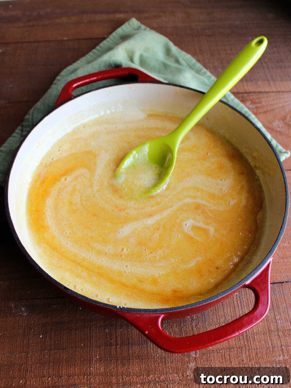 Smooth peach mixture in pan after it has been processed with an immersion blender.