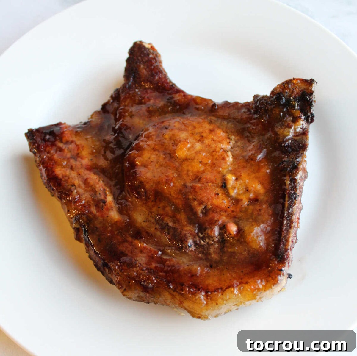 Grilled pork chop glazed with peach habanero jam glaze.