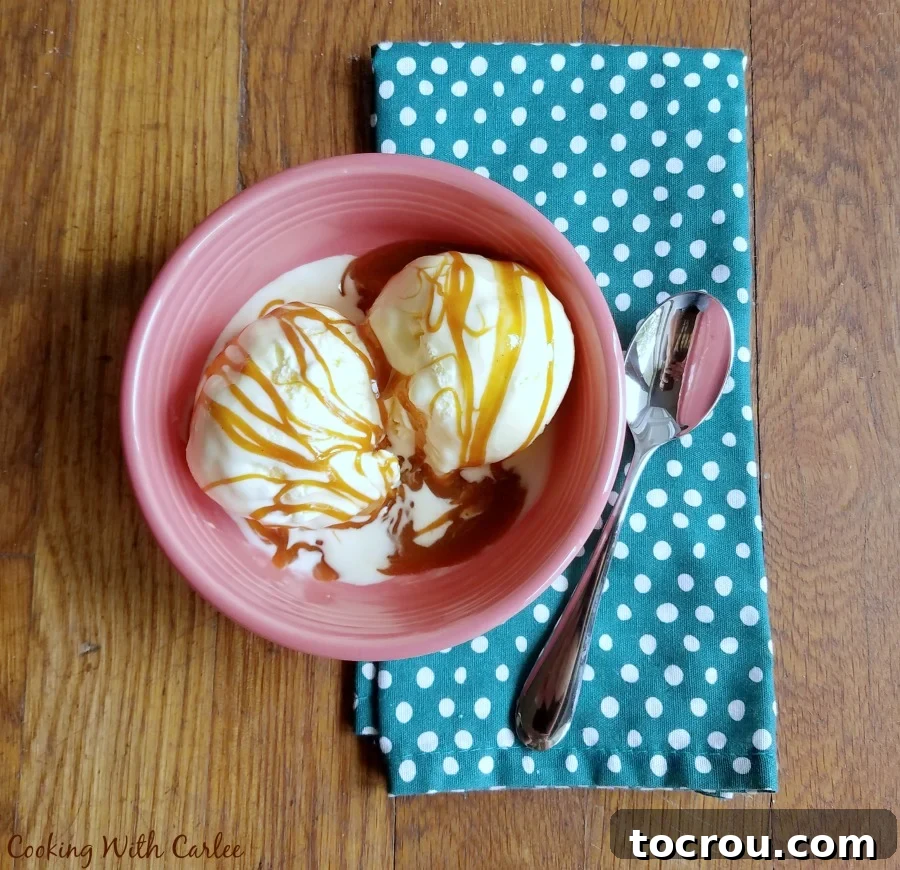 bowl of vanilla ice cream with homemade vanilla cajeta drizzled over the top.