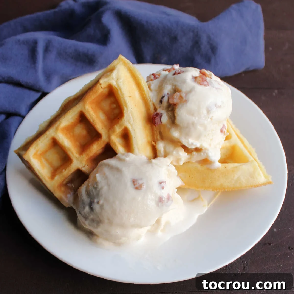 Maple Bacon Bliss Ice Cream 2 Plate of waffles with a couple of scoops of maple bacon ice cream.