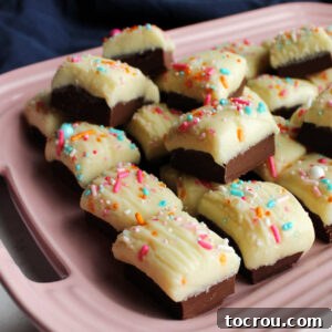Two tone condensed milk fudge on pink platter.