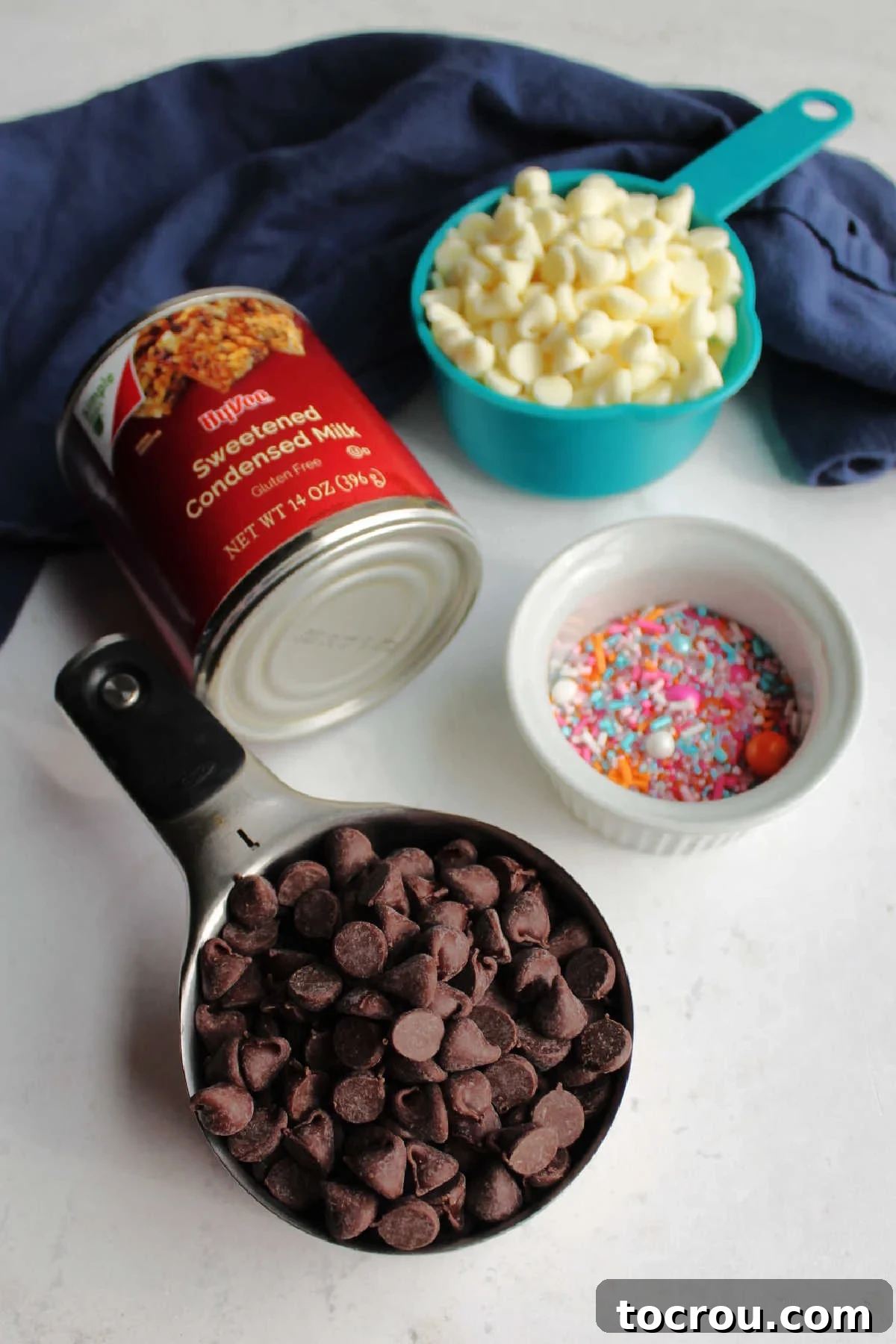 White baking chips. chocolate chips, condensed milk and sprinkles ready to be made into two tone condensed milk fudge.