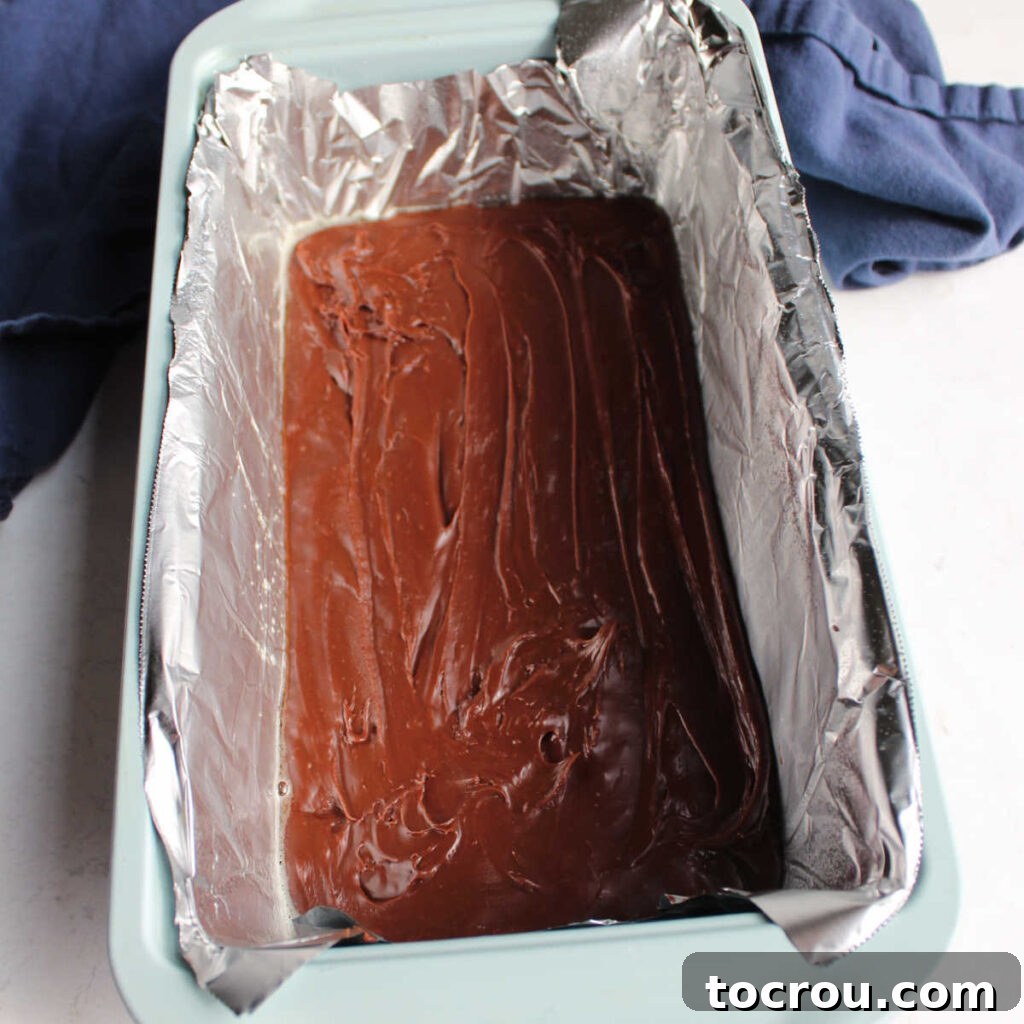 Chocolate fudge spread in foil lined loaf pan.